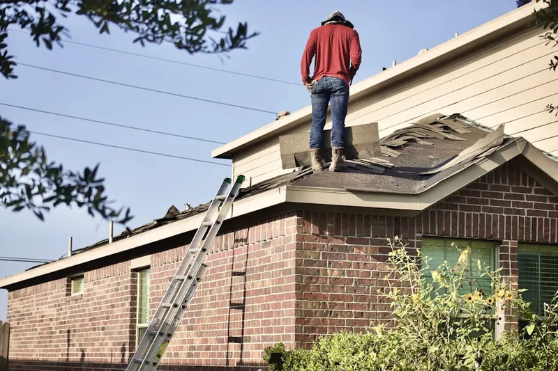 Professional roofer working on a residential roof in Marble Cliff Crossing